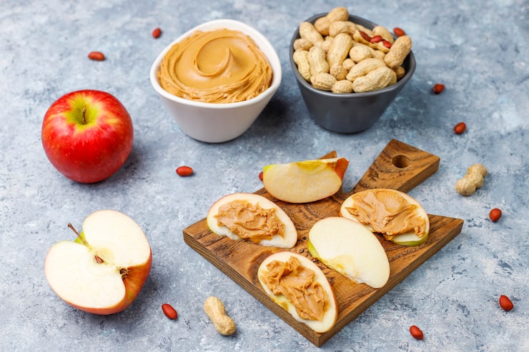 Healthy snacks for focus including almonds and apple slices with peanut butter